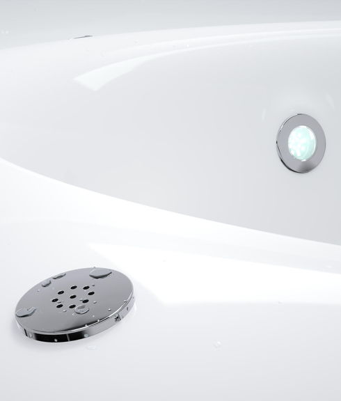 Close up of three bubble system jets mounted in the tub of a wood-fired hot tub