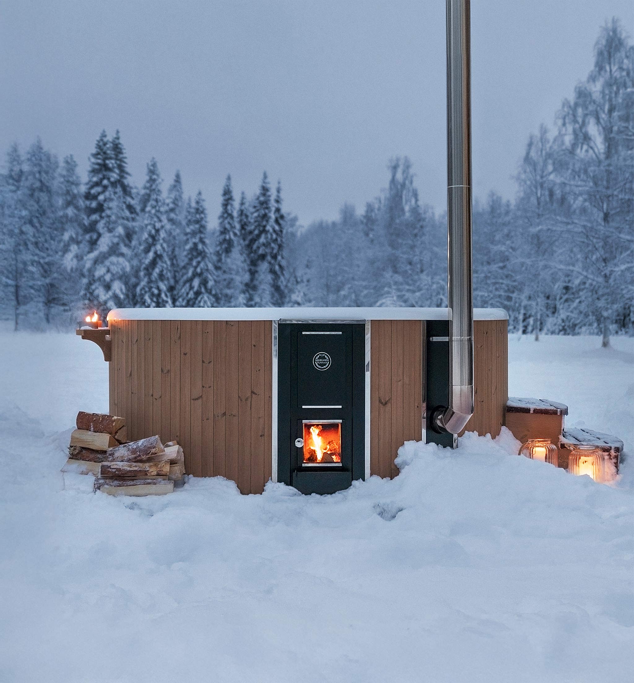 A cozy wooden cabin with a fireplace amidst snowy trees.