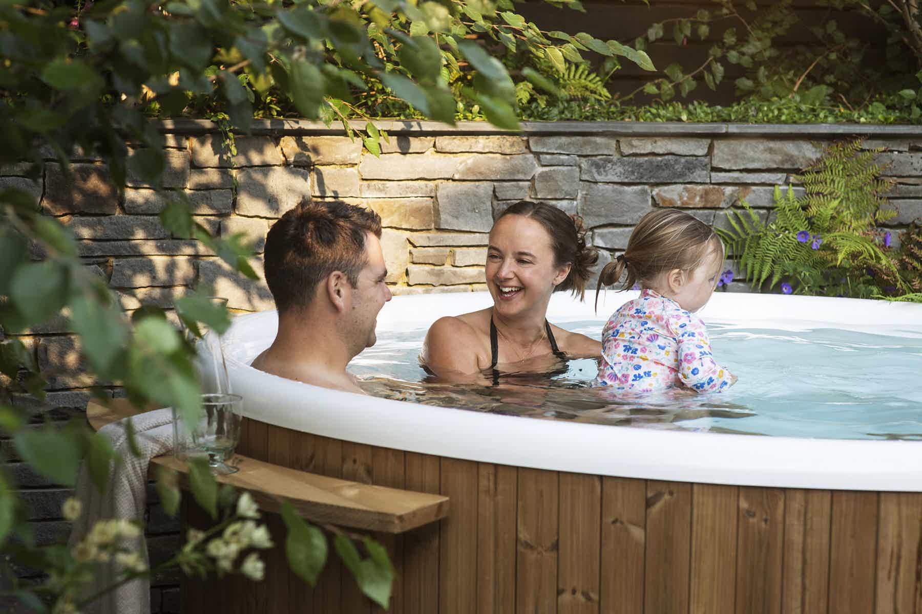 Victoria and her family enjoy a relaxing moment in a Skargards Regal hot tub, surrounded by nature.