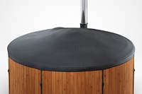 A close-up of a Skargards hot tub with a black canvas cover and silver pole.