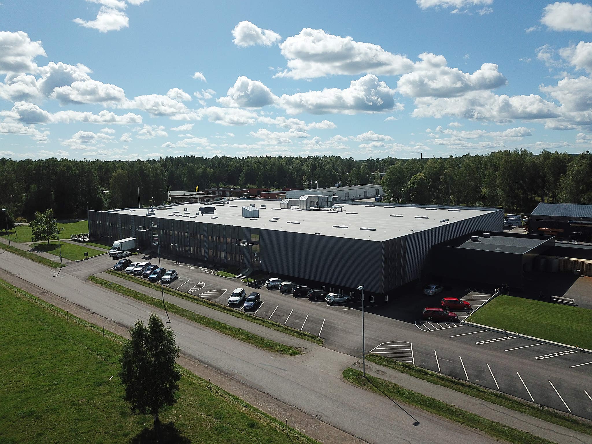 Aerial view of Skargards Hot Tubs factory in a green landscape.