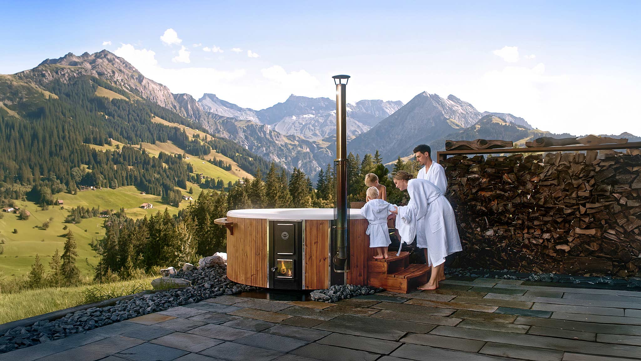 Couple enjoying Skargards Regal hot tub on a deck with mountain view.