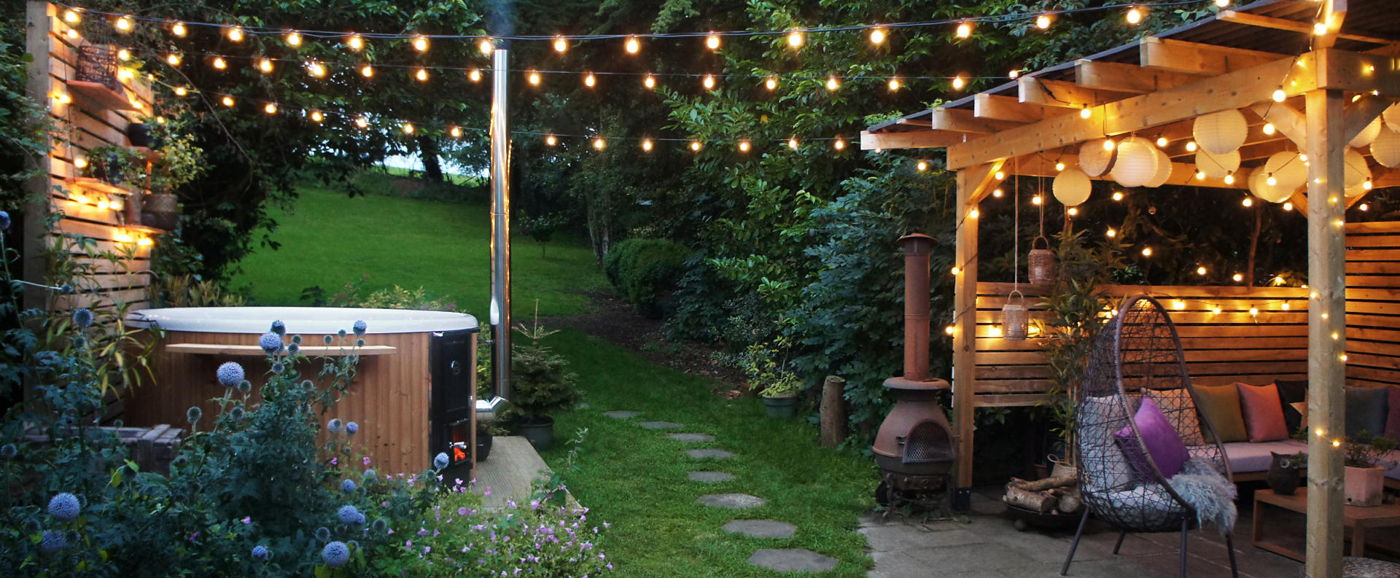 Picture of a garden featuring the hot tub at dusk. 