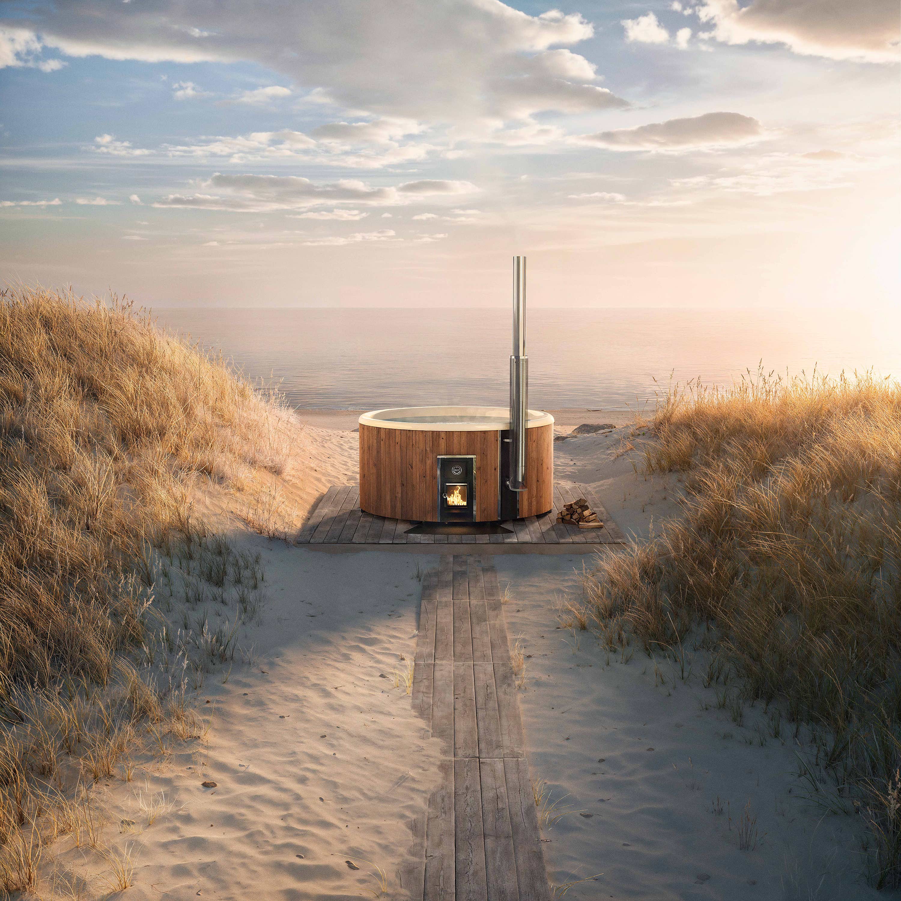 A Skargards Regal hot tub on a sandy beach with a flue guard and wooden walkway.