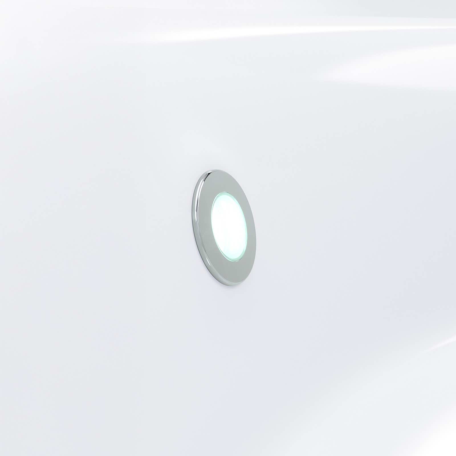Circular light fixture with green and white lights on a white background.