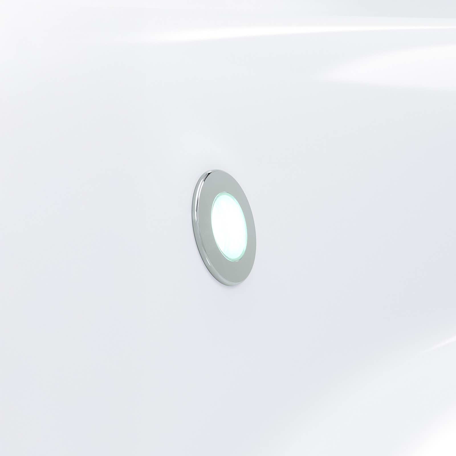 Circular light fixture with green and white lights on a white background.