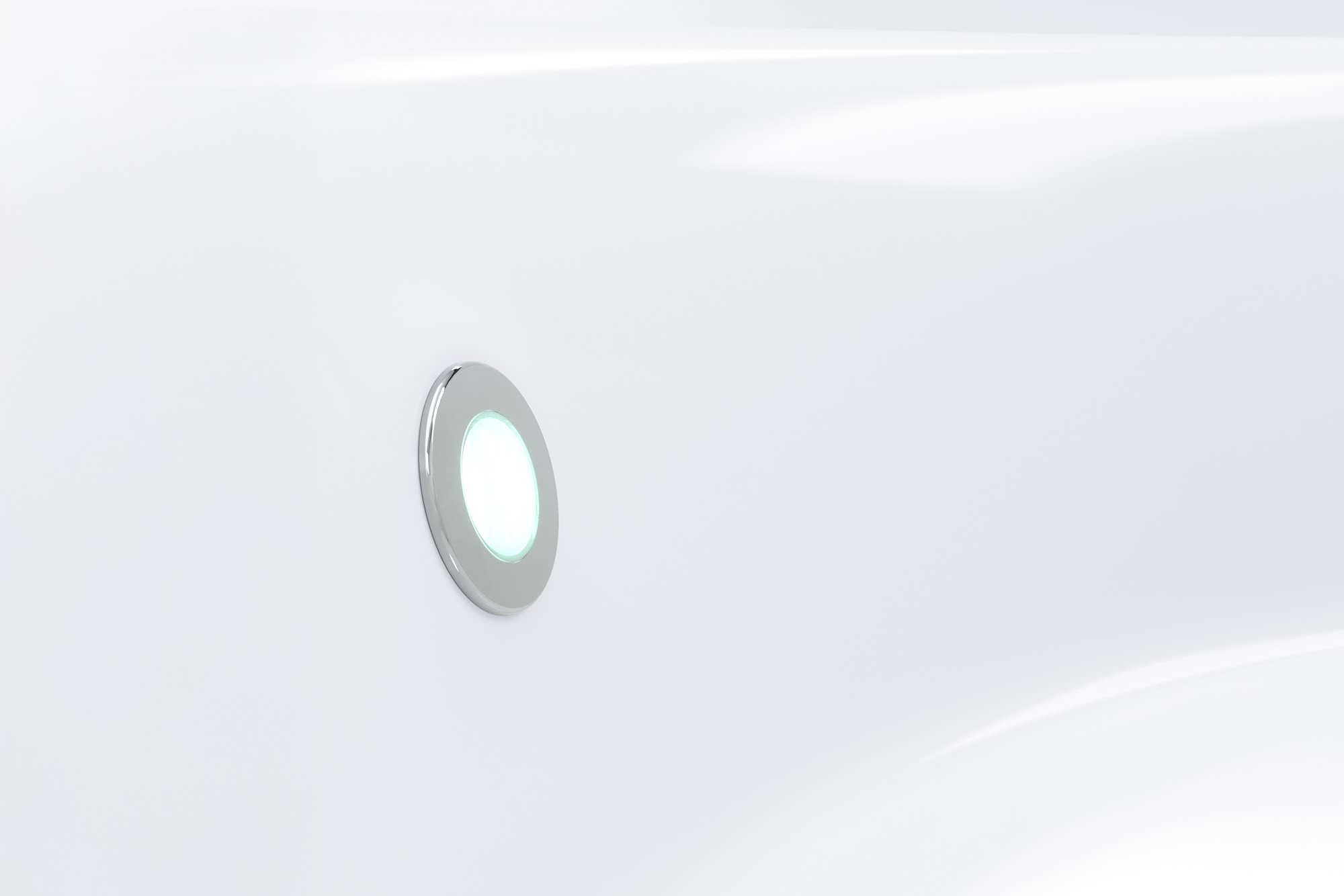 A white surface with a circular light fixture.